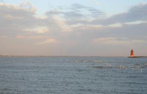 The red of the Delaware Breakwater East End Light stands out against the grey clouds at first light. CHRIS FLOOD PHOTO