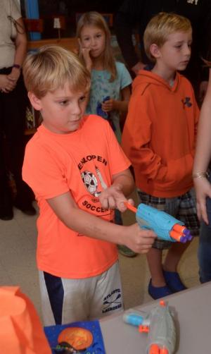 Gavin Sutherland takes aim with at a target in hopes of winning a prize. RON MACARTHUR PHOTO