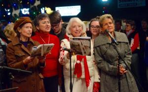 Joyce McCoy, Sandy Roberts, Theda Blackwelder and Carol Hall sing in the season with the Village Improvement Association chorus. RON MACARTHUR PHOTO
