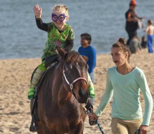 Cecilia Rhine gets a ride on Trophy with Zoe Hegwood leading.