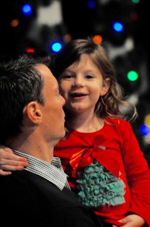 Abiigail Rausch, 3, flashes a Christmas smile as she’s held by her dad, Chris, president of Rehoboth Beach Main Street. RON MACARTHUR PHOTO