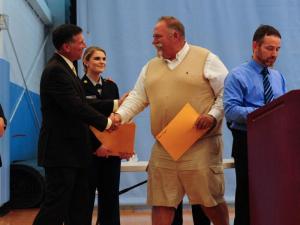 Veteran and Cape employee Paul Rogers, right, is congratulated by Rep. Steve Smyk, R-Milton. DAN COOK PHOTO