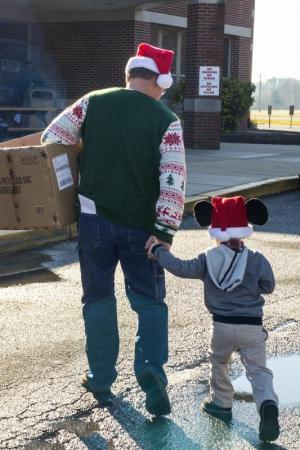 Brian Moyer introduces grandson Evan Moyer to the gift of giving.