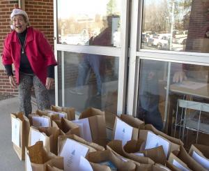Josie Cicerale checks over bags that have pantry items for everyone on the route.