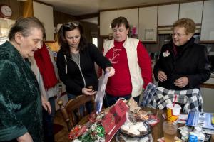 Dorothy Reed looks over the bounty delivered by the family of Albert Lank, shown are (l-r) Reed, Sharon Owens, Katie Joseph, Kim Owens and Janet Lank.