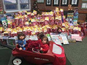 Greco family triplets Giovanni, Mea and Evelina Greco help their mother support a toy drive shortly before Christmas. SUBMITTED PHOTO