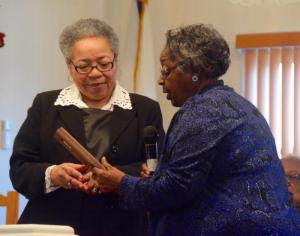 Ardeth Edwards, right, a member of the King celebration committee, presents a plaque to the Rev. Yvonne Brunson, preacher at the Monday service.