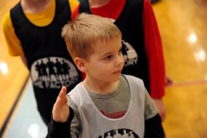 Nehemiah Woods, 4, waits to high-five Cape players taking the court. DAVE FREDERICK PHOTO