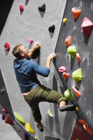 Chris Way, an accomplished climber and setter, climbs the bouldering wall at RISE. NICK ROTH PHOTO