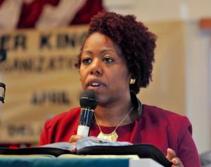 The Rev. Tesha Miller of Macedonia AME Church in Seaford reads from the New Testament of the Bible.