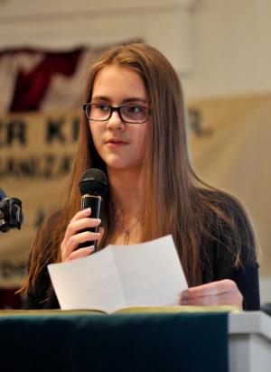 Roisin Greer-Roelants, a freshman at Cape Henlopen High School, reads a poem stating that all lives matter.