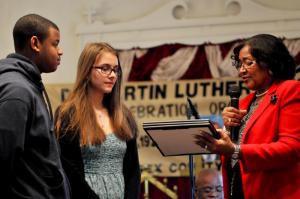 From the left, Donte Privott, a Cape Henlopen High School sophomore, and Roisin Greer-Roelantsm, a Cape freshman, are honored by committee member Janie Miller for taking part in the service.