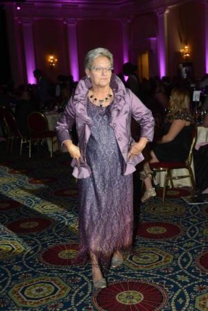 Breast Cancer Survivor Tina Myers of Georgetown walks proudly down the middle of the ballroom during the fashion show. Myers is two-year breast cancer survivor. DBCC