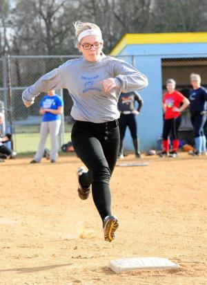 Cape sophomore Chloe Fluharty runs through first during a base-running drill. DAN COOK PHOTO