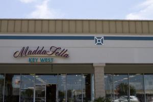 Madda Fella is located between Talbots and Rockport in Tanger Surfside, across from Midway Shopping Center.