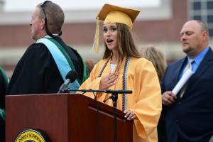 Class of 2017 Treasurer Hannah Derrickson leads the assembly in the Pledge of Allegiance. DAN COOK PHOTO