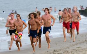 Tyler Lawson of the Fenwick Island Beach Patrol leads the pack and eventually wins the hard sand run.