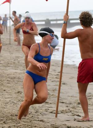 Cape grad and Delaware State Parks Beach Patrol guard Grace Brokaw makes the second-leg turn in the iron man relay.
