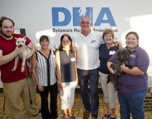 Volunteers and staff members gather for a photo. Shown are (l-r) Mike Gardner holding Prince, Dina Sirabella, Sandy Ahn, Adoption Center Manager Jody RIni, Cindy Jenkins, and Amanda Pope with Carlos.