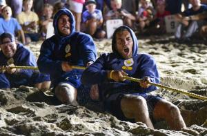 Dewey Beach Patrol guards (l-r) Josh Keil, Edward Kaiser and Sam McMillon get intense during the tug-of-war competition at the 40th annual Rehoboth Beach Patrol Lifeguard Olympics.