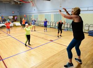 Sussex Family YMCA aerobics instructor Marye Burton, right, leads a senior group through a healthy exercise program.
