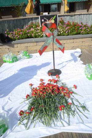 The flowers of remembrance are laid by the red ribbon. AIDS Walk