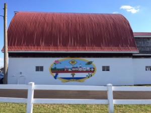The mural is located on the side of the barrel barn at Marvel Carriage Museum in Georgetown.