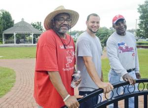 Pastor Troy Hazzard (l-r), Brian Gardner and Stephen Hazzard set up the park for the event.