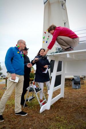 From the left, Rehoboth Beach Main Street’s Trey Kraus, president, Drexel Davidson, beautification committee chairman, Rehoboth Commissioner Kathy McGuiness, liasion, and Cindy Lovett, holiday committee, start a holiday decorating project on the circle.