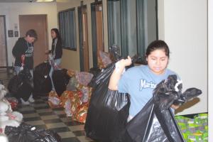 Yaneira Vail helps clear the hallway ahead of Levi Ashley and Ashley Acevedo.