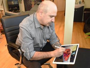 Fred Giovannitti shows how he can create a tattoo on an iPad before ever beginning to work on a client. NICK ROTH PHOTO