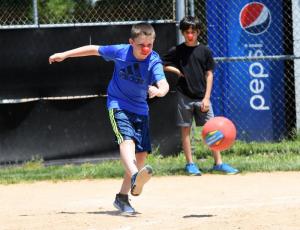 Luke Pickard, 11, drills a kick into the outfield.