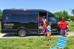 Participants arrive at the field upon a limo-bus.