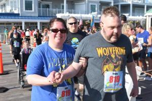 Julie Wilson assists Travis Saverwald through the two-mile walk. Somewhere during the walk a wheelchair was discarded.