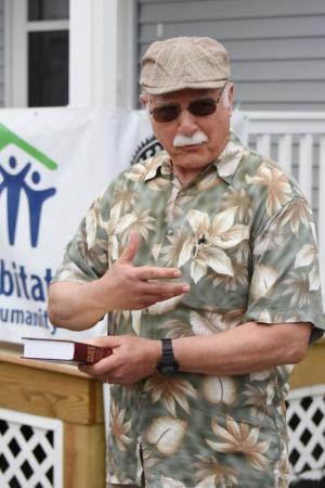Buz Hughes, pastor at Lewes Presbyterian Church, presents a Bible to Blackwell.