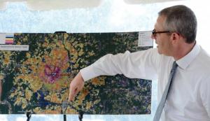 Paul Carliner of Bloosurf uses a map to show the areas that were served during a pilot project.