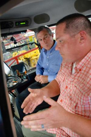 Gov. John Carney, left, gets a brief education on a state-of-the art sprayer from Brent Willin of Willin Farms.