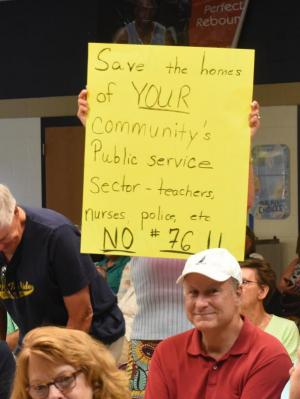 Corinne Daffner holds up a sign opposing the Hudson-Hughes Highway idea. NICK ROTH PHOTO