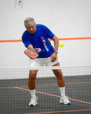 Bert Keller hits back a shot during a practice game. He and his wife, Sue Ingram Keller, hosted the pros during their visit to Sussex County.