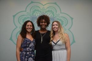 The three healing practitioners gather in front of a mandala. A mandala is a spiritual and ritual symbol in Hinduism and Buddhism, representing the universe. Shown are (l-r) Erin Shivone, Athena Allread and Katie Oswald. Lanikai Wellness