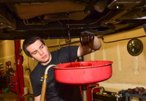 Meineke technician Jimmy Dale performs a basic oil change.