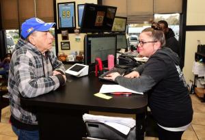 Air Force veteran William Deaver, left, of Rehoboth signs in with service writer Angii Basile.