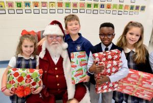 Pictured with Santa are WPS first-graders (l-r) Olivia Mason, Maximus Farrell, Darius Jones, and Sloane Smith.