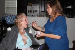 Caretaker Iris Brown gives Purdy a snack. MELISSA STEELE PHOTO