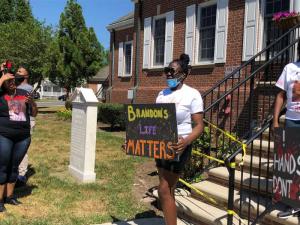 Brandon Roberts’ girlfriend, Erica Jones, in front of Milford City Hall.
