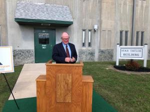 Former DOC Commissioner Stan Taylor talks to the crowd after the sign renaming the SCI treatment building in his honor has been revealed.