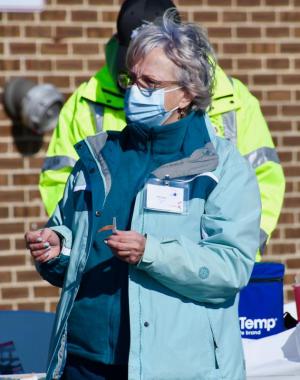 Nurse Elaine Morris prepares to administer a COVID-19 vaccine.