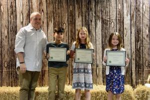 Sussex County 4-H volunteer Stan Bradley, left, congratulates Exploring 4-H Award recipients (l-r) Lucas Marquez, Emorie Jackson and Julia Freebery. Not pictured is Raegan O’Day.