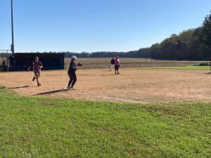 Jake Hunsicker tries to beat out a ground ball at the Lenny Williams Cancer Sucks Softball Tournament in Milton Oct. 15.