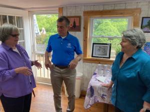 Marie Mayor, left, talks with Gov. John Carney and artist Jane Duffy at Lavender Fields’ art studio May 24.